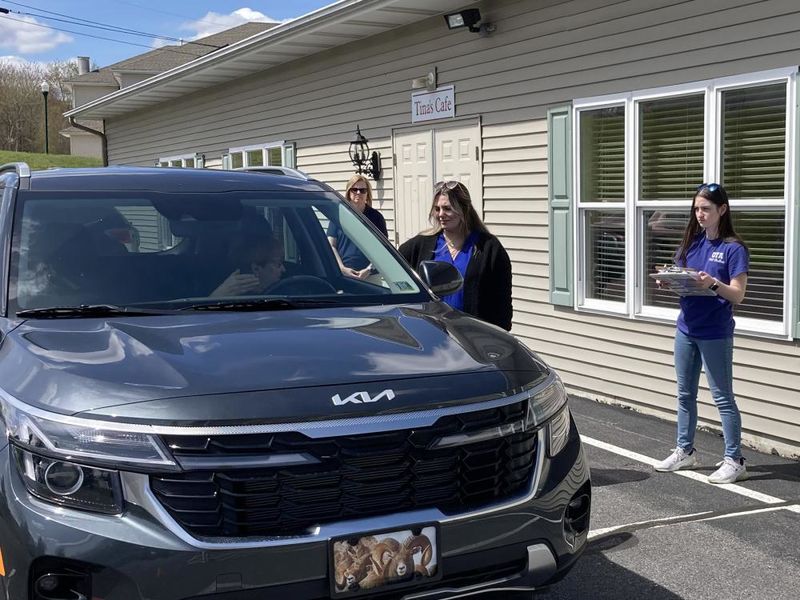 Penn State DuBois OTA students Emily Busija, center, and Maddie Barsh, right, work through a CarFit session as Amy Fatula, assistant teaching professor, watches on at the health and wellness fair at Christ the King Manor on April 25.